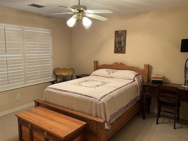 carpeted bedroom featuring baseboards, visible vents, and ceiling fan