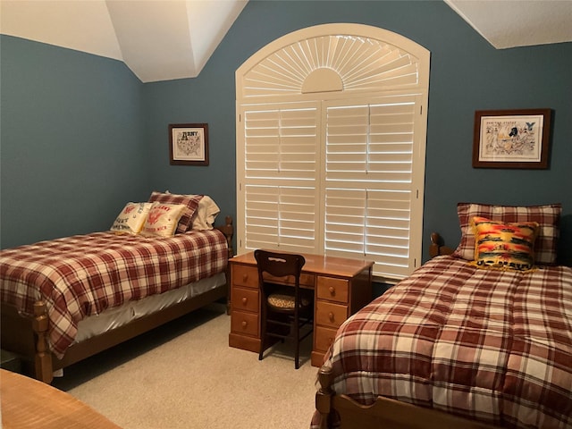 bedroom with light carpet and lofted ceiling