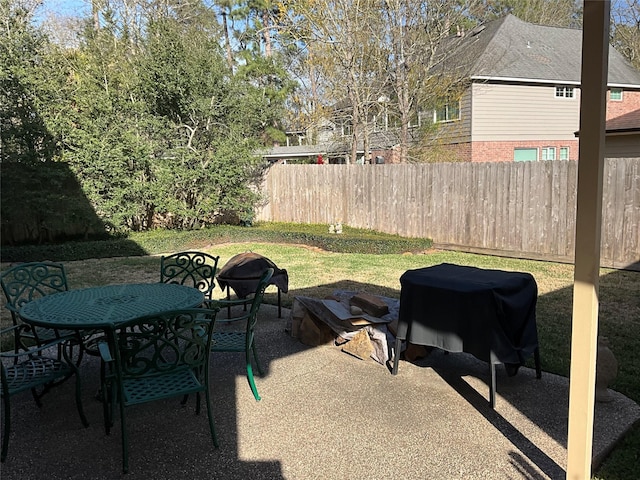 view of patio with outdoor dining area and fence