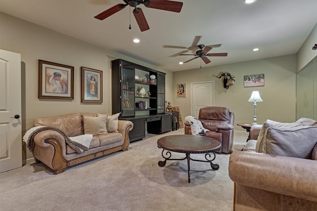 living area featuring recessed lighting, light colored carpet, and a ceiling fan