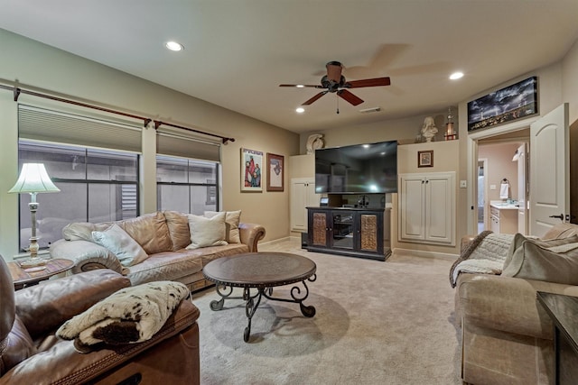 living area with a ceiling fan, recessed lighting, light colored carpet, and visible vents