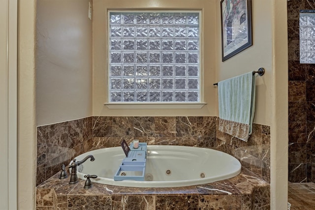 full bathroom featuring a tub with jets