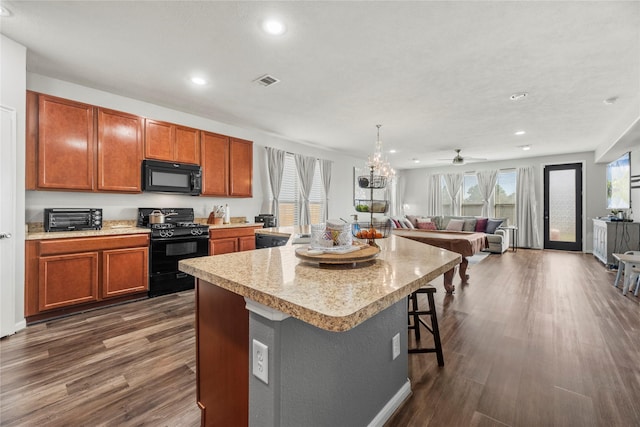 3615 Hawley Creek Dr, Spring, TX 77386 - kitchen with black appliances, recessed lighting, dark wood finished floors, open floor plan, and a large island