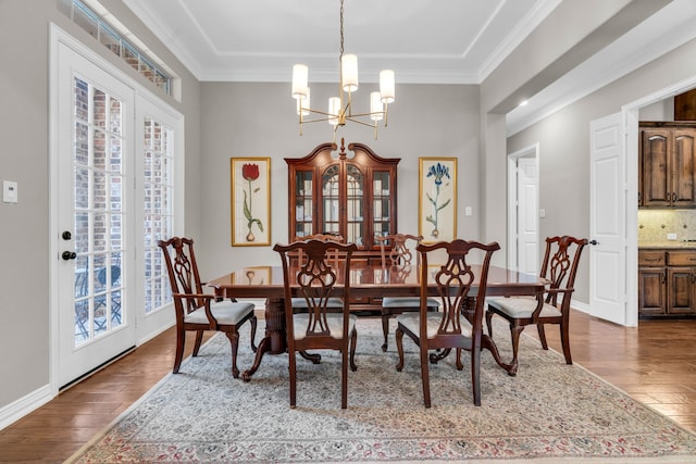 dining area featuring a healthy amount of sunlight, crown molding, and hardwood / wood-style floors