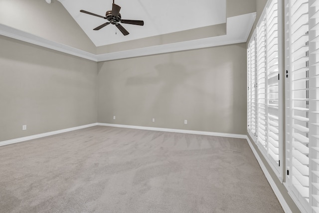 unfurnished room with carpet flooring, baseboards, lofted ceiling, and ceiling fan