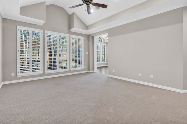 spare room with carpet flooring, baseboards, high vaulted ceiling, and a ceiling fan