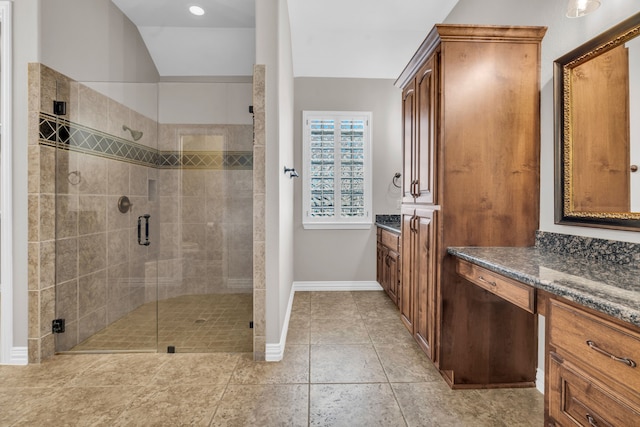 full bathroom with tile patterned flooring, a stall shower, vanity, and baseboards