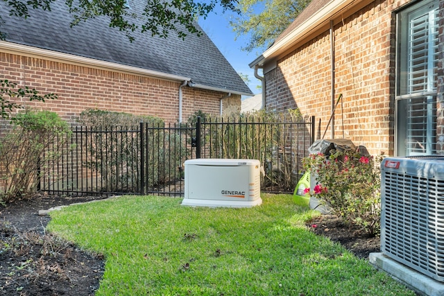 view of yard with central AC and fence