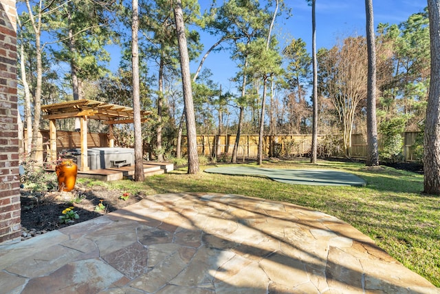 view of yard featuring a patio area, a hot tub, and a fenced backyard