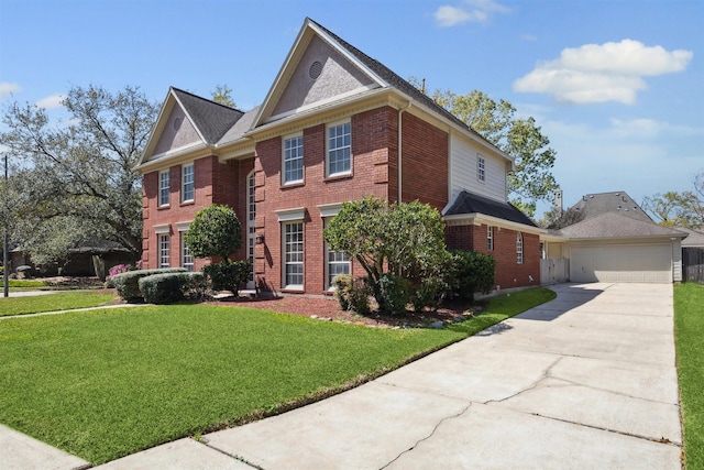 view of front of property featuring brick siding, a front lawn, a garage, an outdoor structure, and driveway