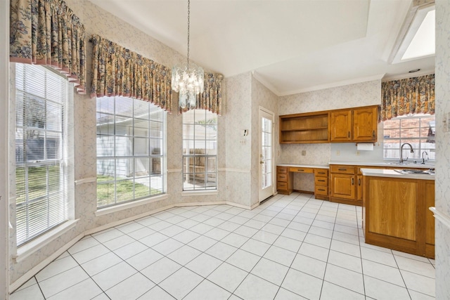 kitchen with open shelves, wallpapered walls, light countertops, brown cabinetry, and a sink