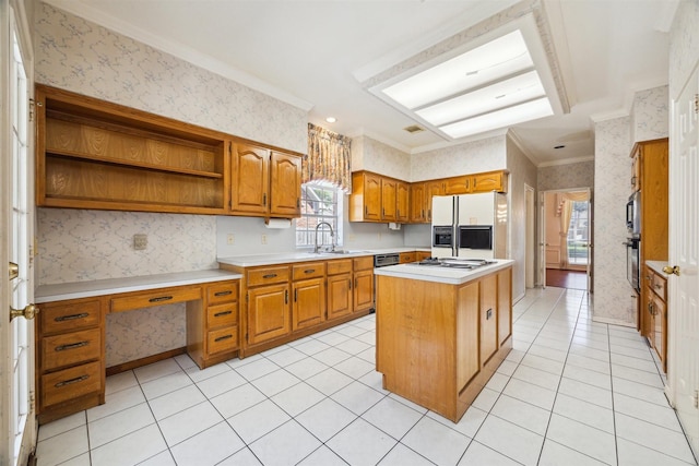 kitchen featuring wallpapered walls, light countertops, appliances with stainless steel finishes, brown cabinetry, and a sink