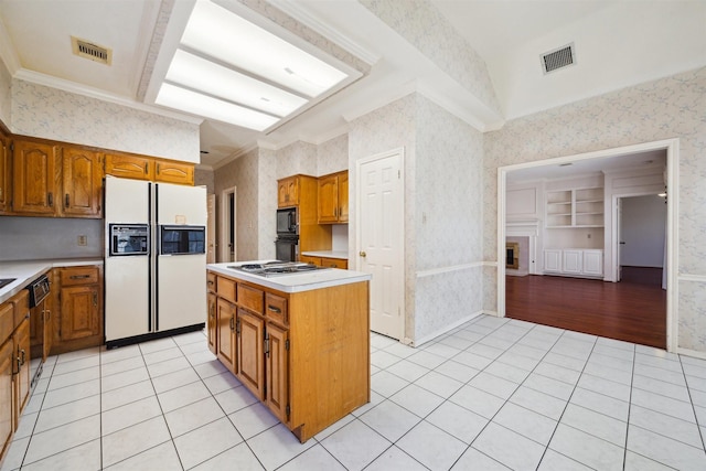 kitchen with wallpapered walls, black appliances, light countertops, and visible vents