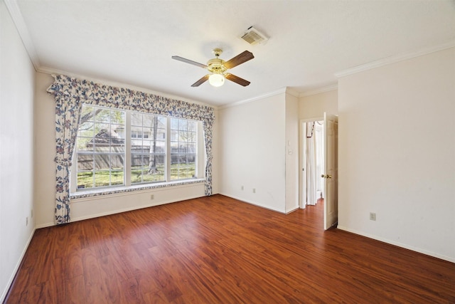 spare room featuring visible vents, crown molding, ceiling fan, and wood finished floors