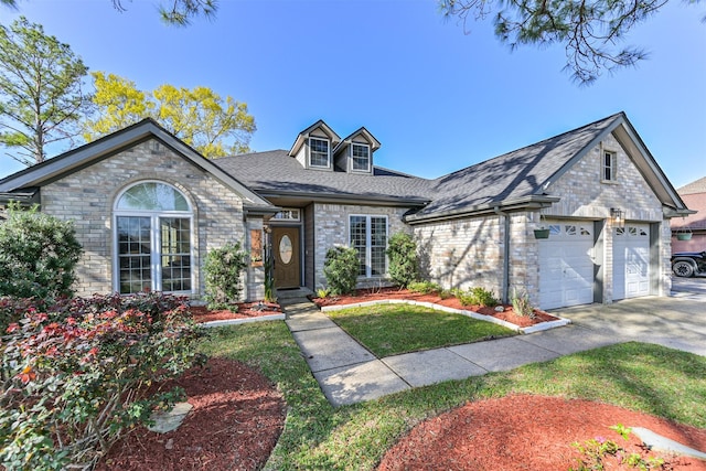 view of front of house with brick siding, driveway, a shingled roof, and a garage