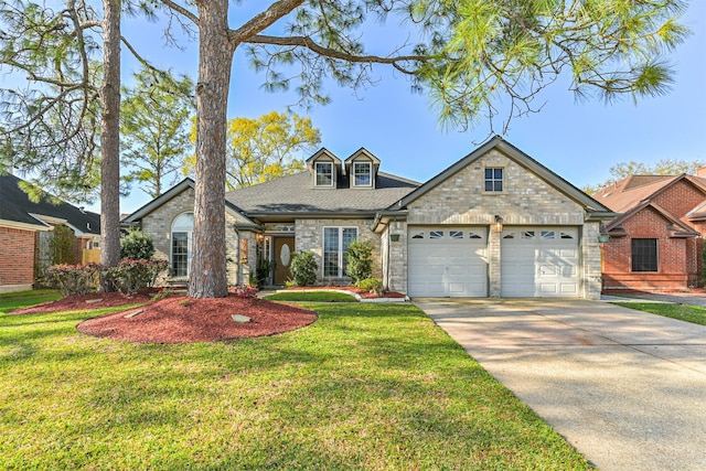 view of front of property featuring brick siding, a front yard, roof with shingles, a garage, and driveway