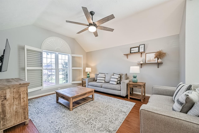 living room with baseboards, lofted ceiling, ceiling fan, and wood finished floors