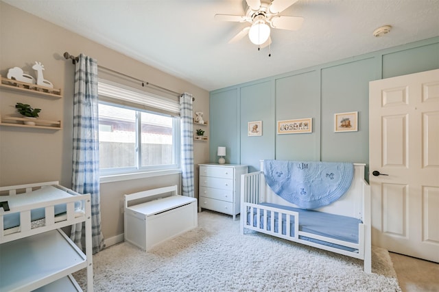 bedroom with a decorative wall and ceiling fan