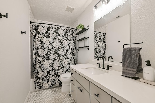 bathroom with vanity, toilet, visible vents, and a textured ceiling