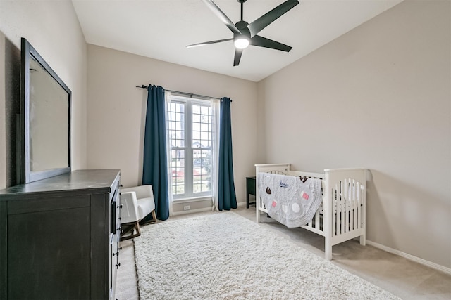 bedroom featuring baseboards, light carpet, and a ceiling fan