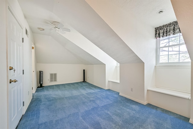 bonus room featuring lofted ceiling, visible vents, carpet floors, and ceiling fan