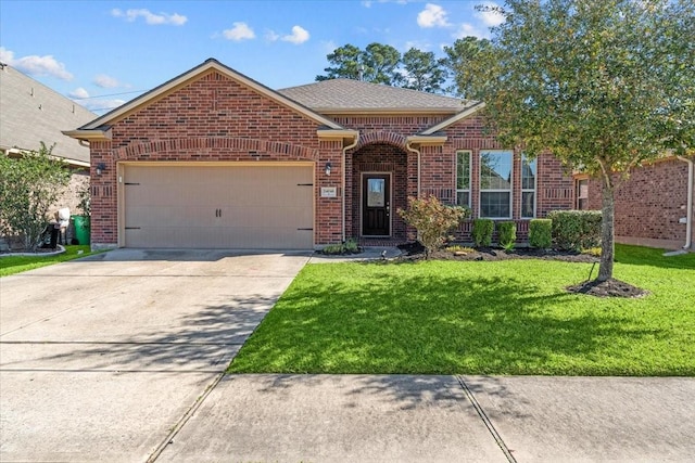 ranch-style home featuring a garage, driveway, brick siding, and a front yard