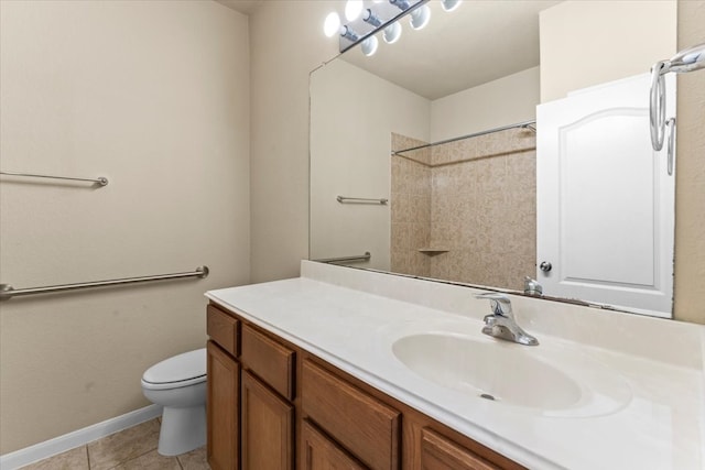 bathroom with vanity, baseboards, tile patterned flooring, walk in shower, and toilet