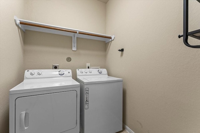 washroom featuring laundry area and separate washer and dryer