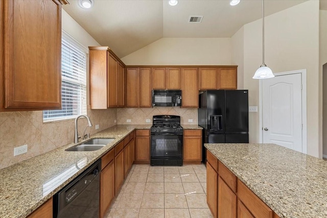 kitchen with visible vents, brown cabinets, black appliances, and a sink