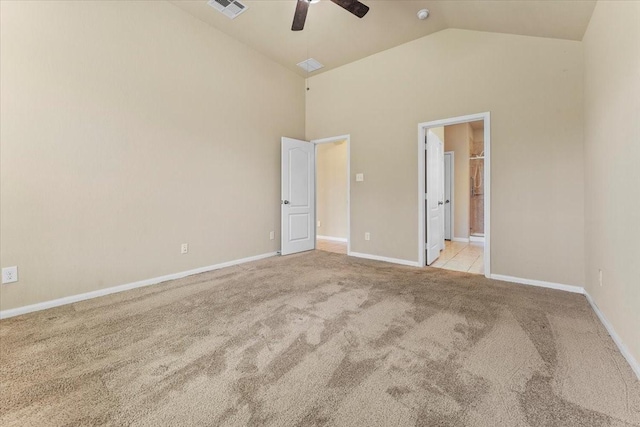 unfurnished bedroom featuring visible vents, baseboards, carpet flooring, ensuite bathroom, and high vaulted ceiling