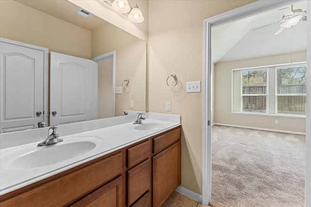 bathroom featuring ceiling fan, double vanity, visible vents, and a sink