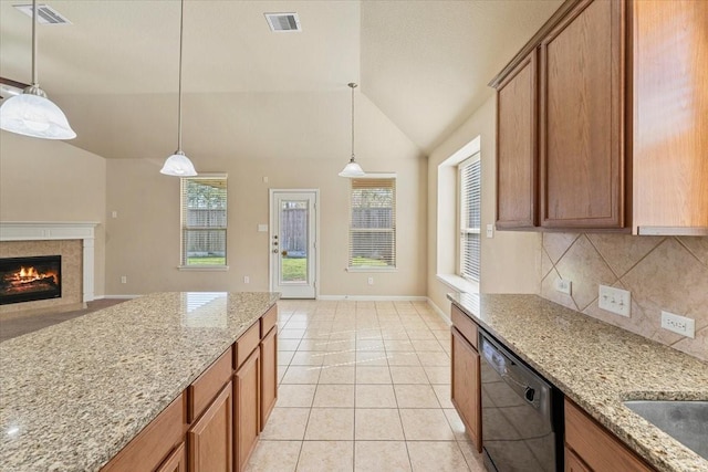 kitchen with light tile patterned floors, visible vents, lofted ceiling, and black dishwasher