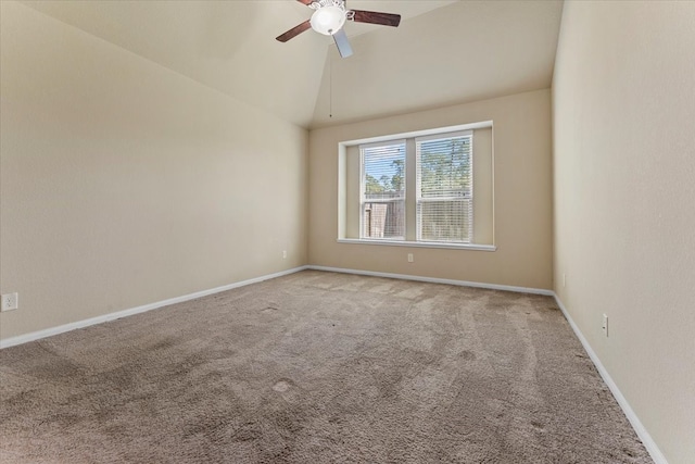 empty room featuring baseboards, carpet floors, a ceiling fan, and vaulted ceiling