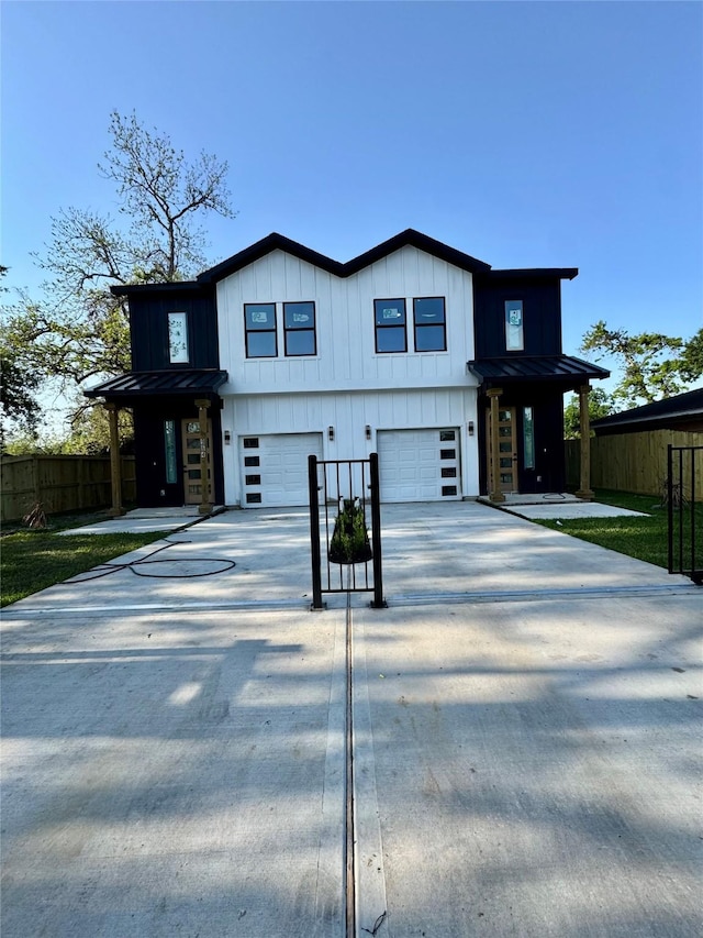 964 Lucky St, Houston, TX 77088 - view of front of home with a garage, board and batten siding, a standing seam roof, and driveway