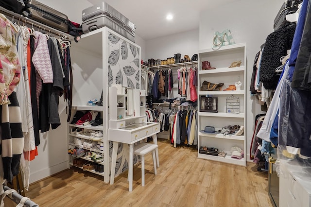 walk in closet with wood finished floors