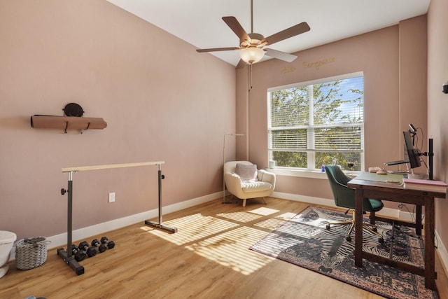 office space featuring ceiling fan, baseboards, and wood finished floors