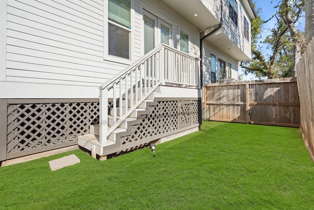 view of yard featuring stairway and fence