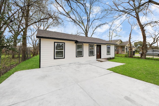 ranch-style home featuring a patio, a front yard, and fence