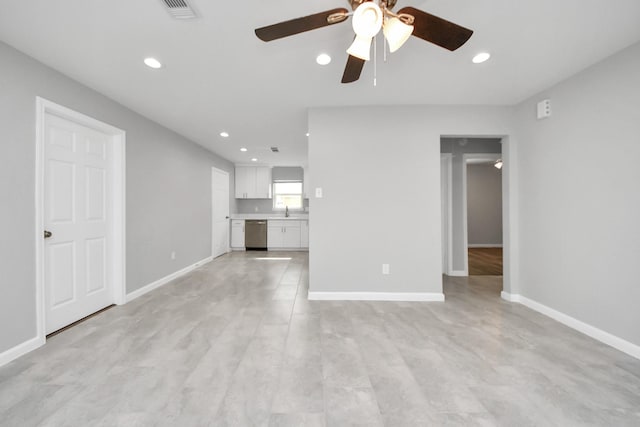 unfurnished living room with visible vents, ceiling fan, and baseboards