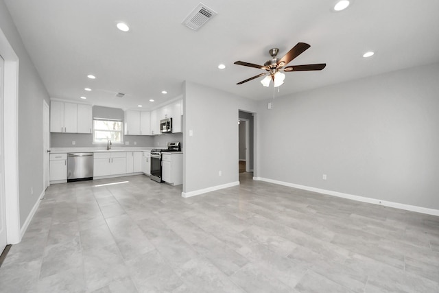 unfurnished living room featuring a ceiling fan, baseboards, visible vents, recessed lighting, and a sink