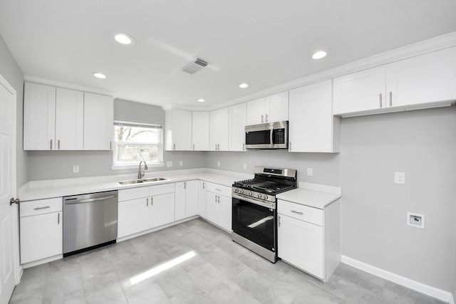 kitchen with visible vents, light countertops, appliances with stainless steel finishes, white cabinets, and a sink