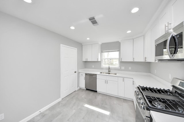 kitchen with white cabinetry, visible vents, appliances with stainless steel finishes, and a sink