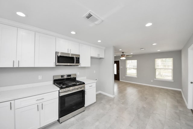 kitchen with visible vents, a ceiling fan, white cabinetry, appliances with stainless steel finishes, and light countertops