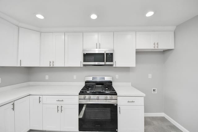 kitchen with baseboards, recessed lighting, light countertops, white cabinets, and appliances with stainless steel finishes