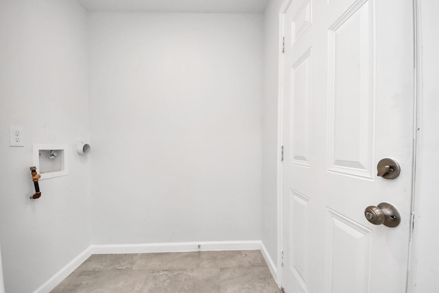 clothes washing area featuring laundry area, baseboards, and washer hookup