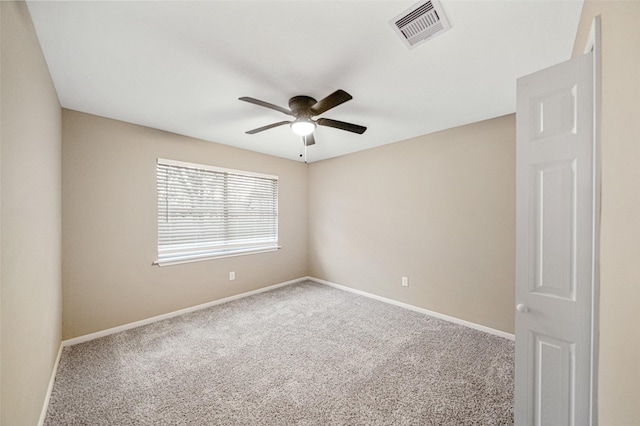 spare room featuring visible vents, baseboards, ceiling fan, and carpet flooring