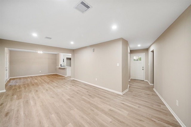 unfurnished living room with visible vents, recessed lighting, baseboards, and light wood-style floors