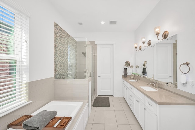 full bathroom with tile patterned floors, visible vents, a stall shower, a sink, and double vanity