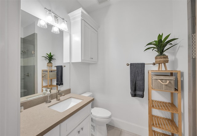 full bath with baseboards, toilet, a tile shower, tile patterned floors, and vanity