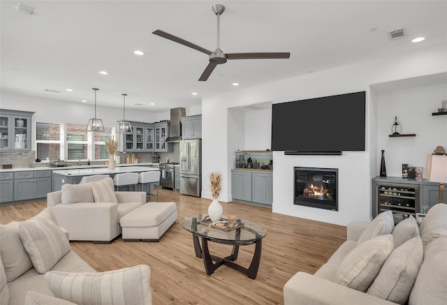 living area with visible vents, recessed lighting, light wood-style floors, and ceiling fan